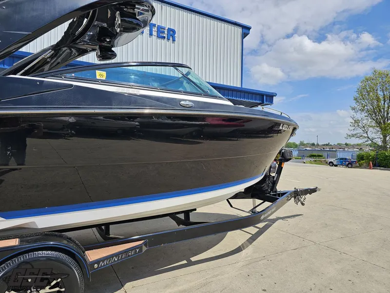 Slide: The Image of 2018 Monterey 258 Super Sport boat on trailer, parked outside a building under a blue sky. - 3