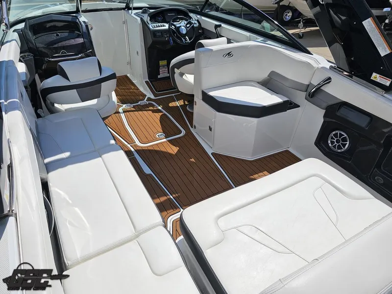Slide: The Image of 2018 Monterey 258 Super Sport boat interior with white seating and wood flooring. - 30