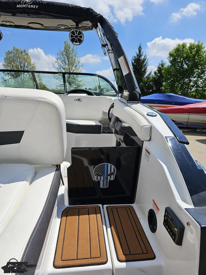 Slide: The Image of 2018 Monterey 258 Super Sport boat interior with white seating and teak flooring. - 32