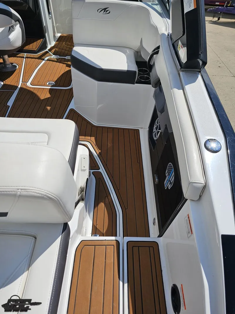 Slide: The Image of 2018 Monterey 258 Super Sport boat interior with teak flooring and white seating. - 33