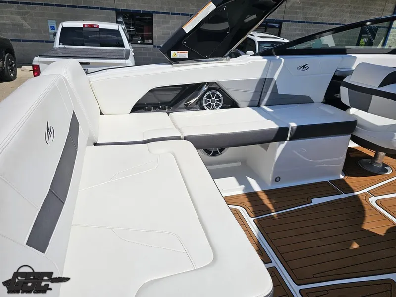 Slide: The Image of 2018 Monterey 258 Super Sport boat interior with white seating and wood flooring. - 38