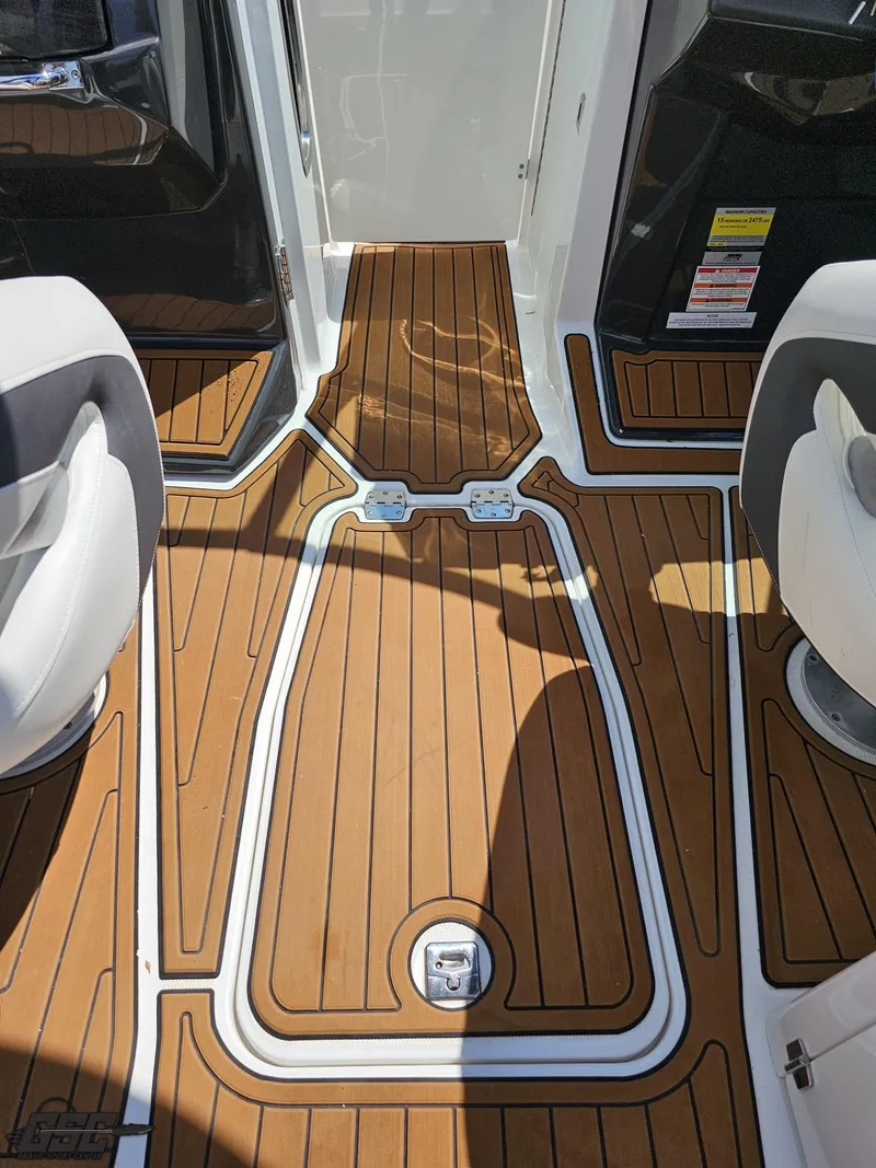 Slide: The Image of 2018 Monterey 258 Super Sport boat interior with teak-style flooring and white seating. - 39