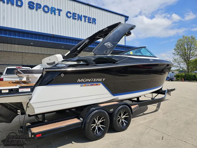 Slide: The Image of 2018 Monterey 258 Super Sport boat on trailer outside a sport center. - 5
