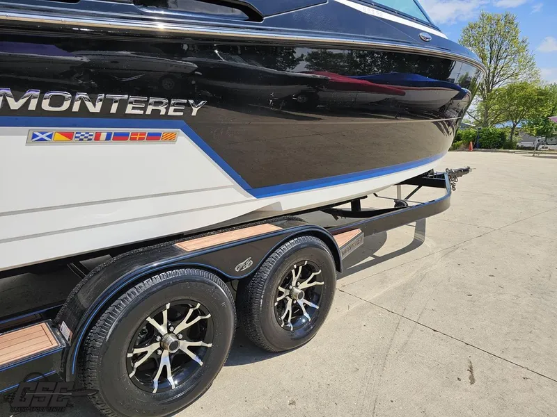 Slide: The Image of 2018 Monterey 258 Super Sport boat on trailer, featuring sleek design and vibrant decals. - 8