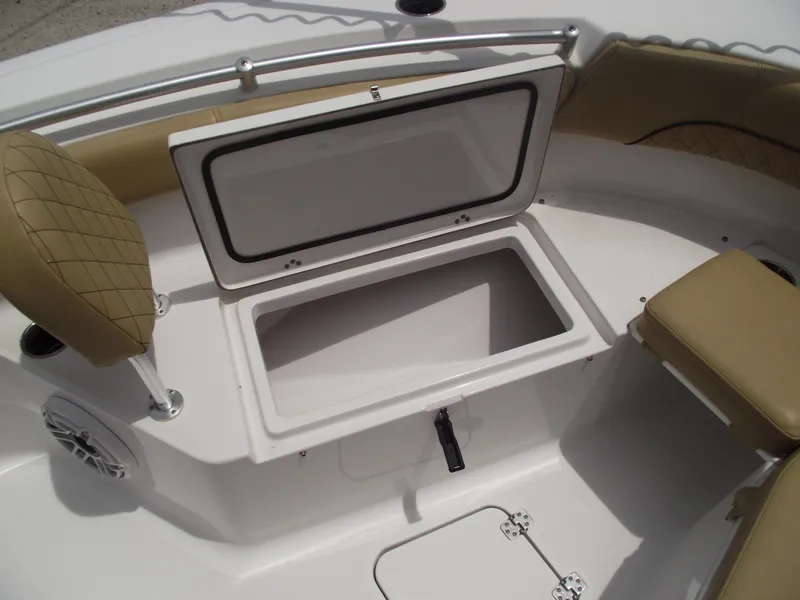 Slide: The Image of 2021 Sportsman Open 212 Center Console boat with open storage compartment and cushioned seating. - 10