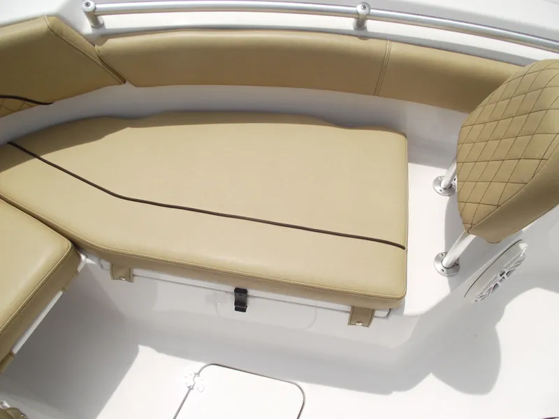 Slide: The Image of 2021 Sportsman Open 212 Center Console boat interior with tan cushioned seating. - 11