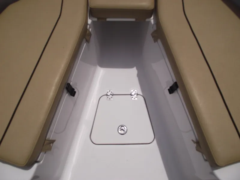 Slide: The Image of 2021 Sportsman Open 212 Center Console boat interior with tan seating and storage hatch. - 14