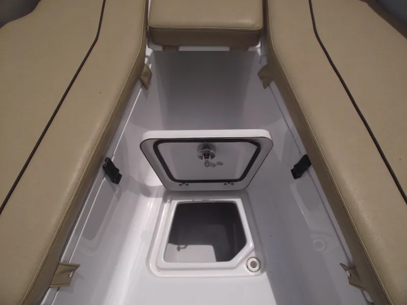 Slide: The Image of 2021 Sportsman Open 212 Center Console boat storage compartment with beige seating. - 15