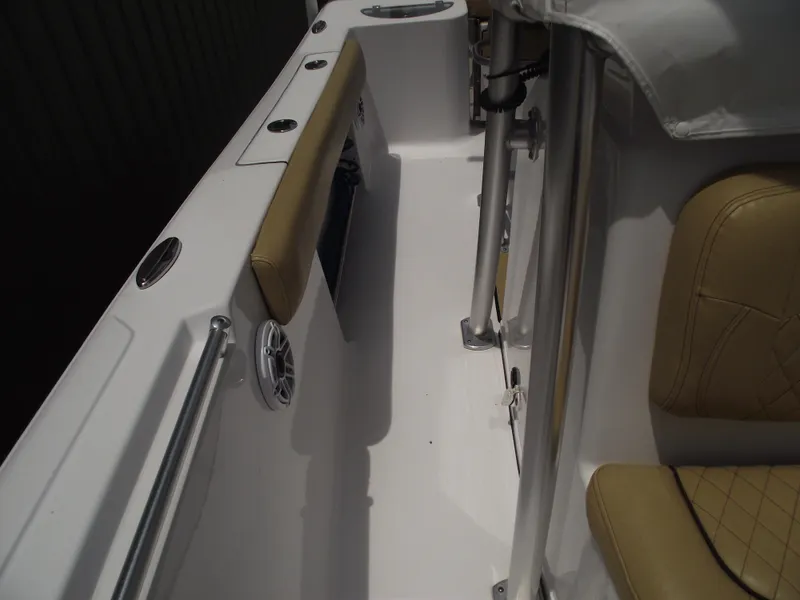 Slide: The Image of 2021 Sportsman Open 212 Center Console boat interior with tan seating and stainless steel fixtures. - 16