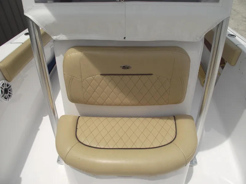 Slide: The Image of 2021 Sportsman Open 212 Center Console, beige cushioned seating detail. - 17