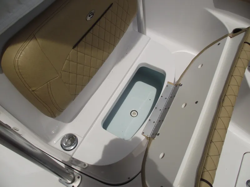 Slide: The Image of 2021 Sportsman Open 212 Center Console boat seat with storage compartment open. - 18