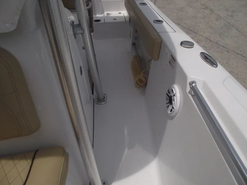 Slide: The Image of 2021 Sportsman Open 212 Center Console interior with beige seating and speaker. - 20