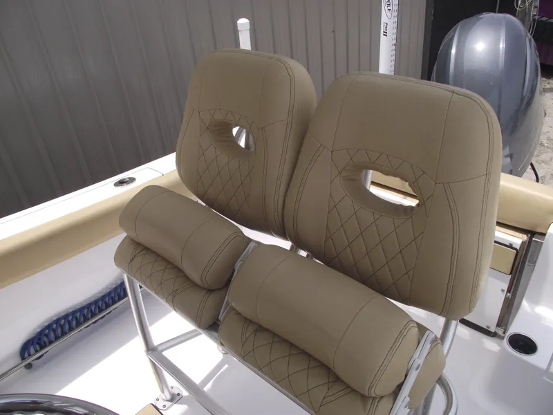 Slide: The Image of 2021 Sportsman Open 212 Center Console boat seats with tan upholstery and diamond stitching. - 25