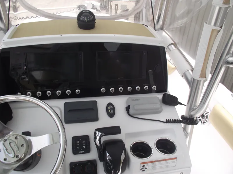 Slide: The Image of 2021 Sportsman Open 212 Center Console dashboard with steering wheel and navigation equipment. - 27