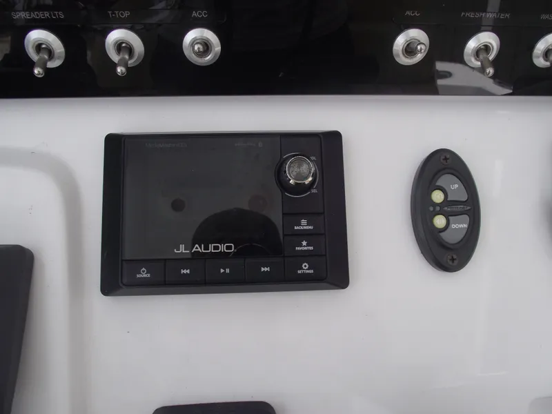 Slide: The Image of Control panel of a 2021 Sportsman Open 212 Center Console boat with JL Audio system. - 28