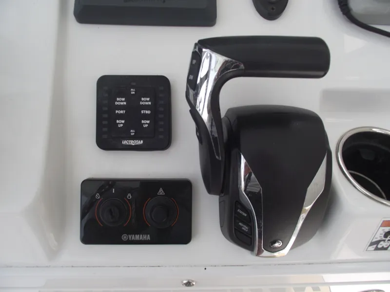 Slide: The Image of 2021 Sportsman Open 212 Center Console controls with Yamaha throttle and trim tabs. - 29