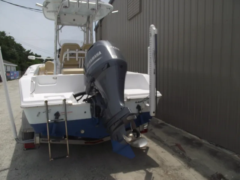 Slide: The Image of 2021 Sportsman Open 212 Center Console boat with Yamaha outboard motor, docked outdoors. - 3