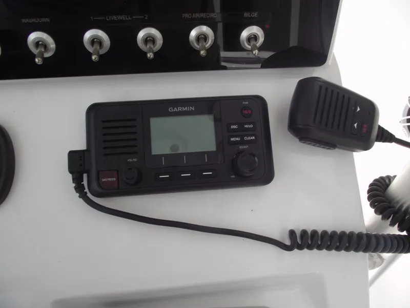 Slide: The Image of Garmin marine radio and microphone on 2021 Sportsman Open 212 Center Console boat. - 30