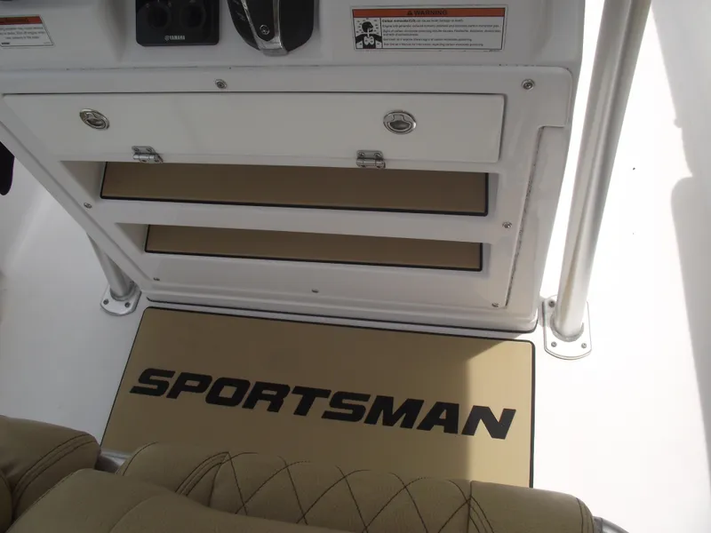 Slide: The Image of 2021 Sportsman Open 212 Center Console interior with storage compartments and branded mat. - 31