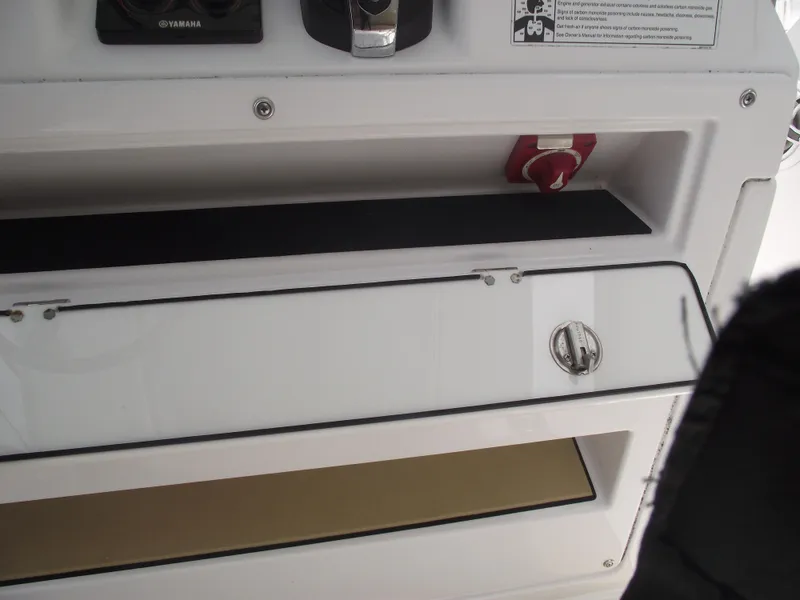 Slide: The Image of 2021 Sportsman Open 212 Center Console dashboard with storage compartments and control panel. - 34