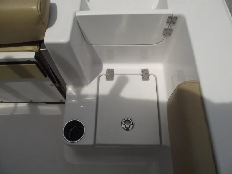 Slide: The Image of 2021 Sportsman Open 212 Center Console boat interior with storage compartment and cup holder. - 37