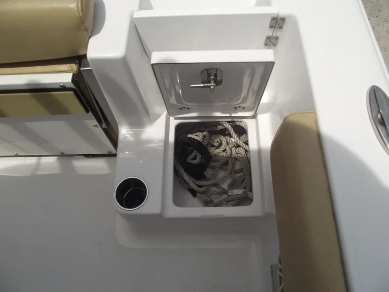 Slide: The Image of 2021 Sportsman Open 212 Center Console boat interior with storage compartment and cup holder. - 38