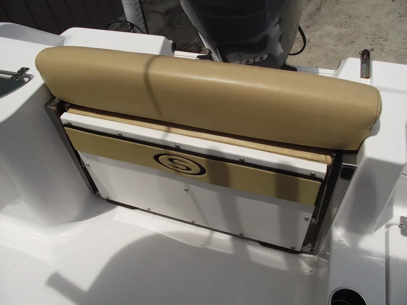 Slide: The Image of 2021 Sportsman Open 212 Center Console boat seat with tan cushion and storage compartment. - 41