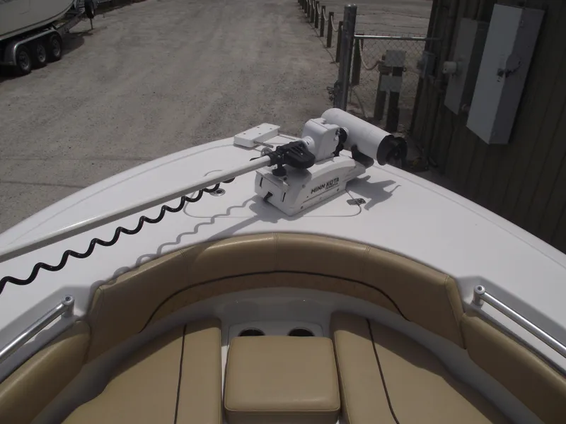 Slide: The Image of 2021 Sportsman Open 212 Center Console boat with tan seating and trolling motor. - 6