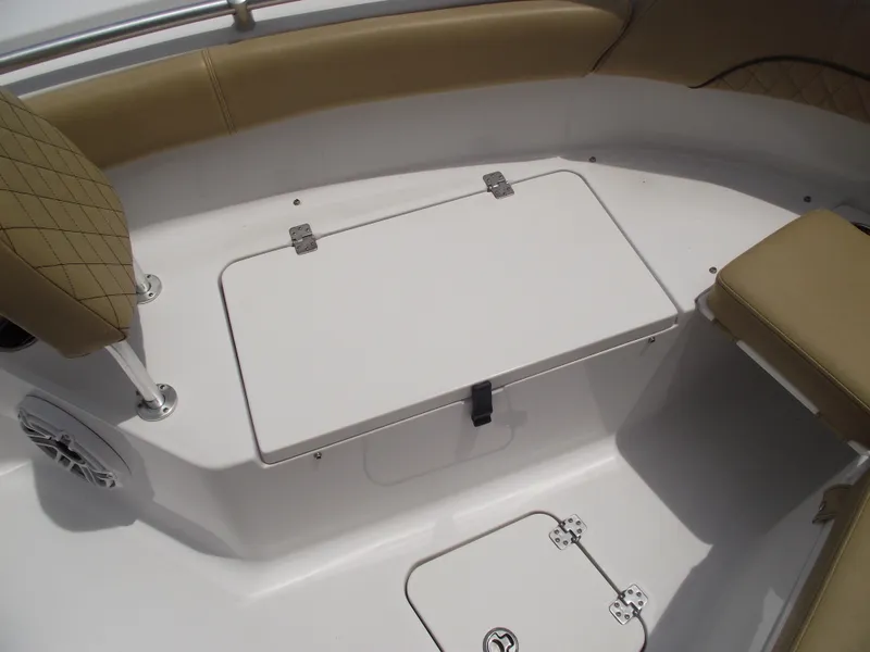 Slide: The Image of 2021 Sportsman Open 212 Center Console boat interior with tan seating and storage compartments. - 9