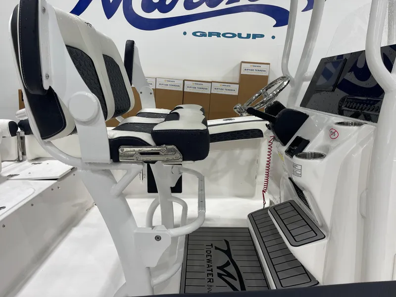 Slide: The Image of 2025 Tidewater 210LXF boat interior with modern seating and steering console. - 12
