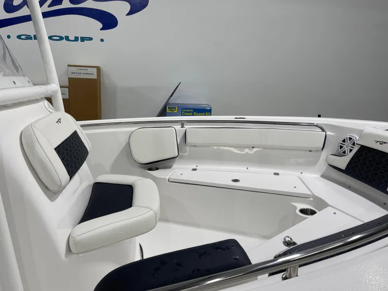 Slide: The Image of 2025 Tidewater 210LXF boat interior with white and black seating, sleek design. - 14