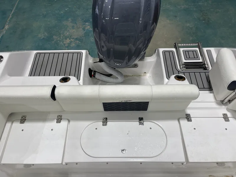Slide: The Image of 2025 Tidewater 210LXF boat deck with motor and seating area. - 15