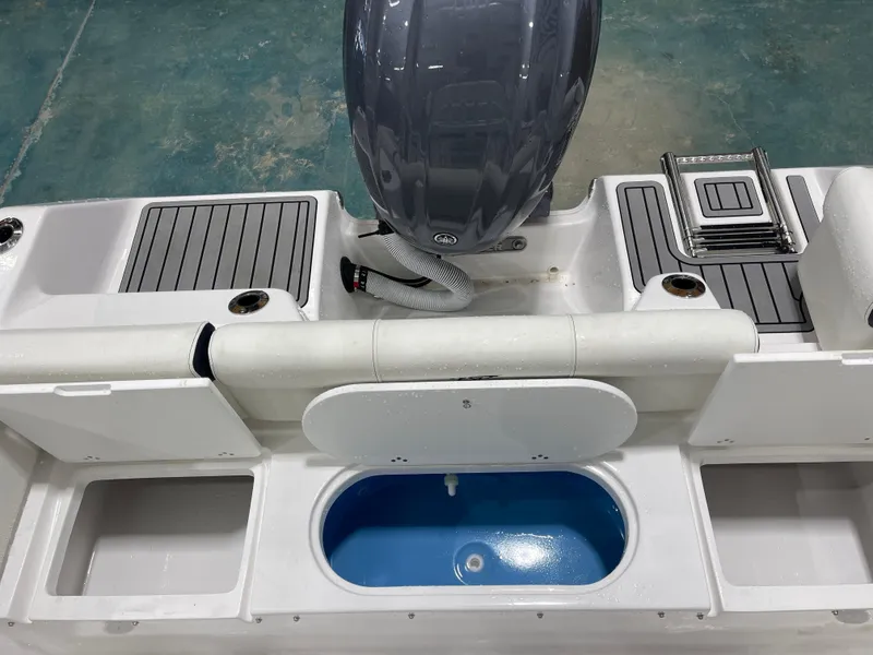 Slide: The Image of 2025 Tidewater 210LXF boat interior with motor, storage compartments, and seating. - 16