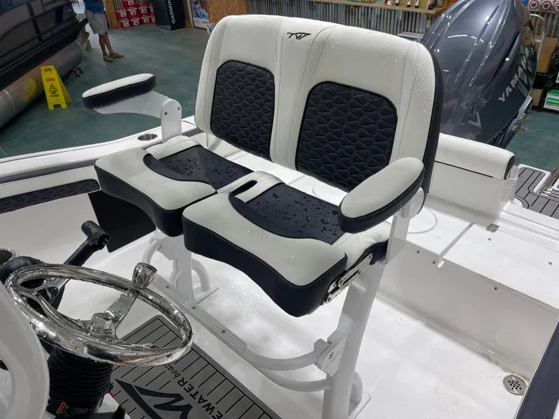 Slide: The Image of 2025 Tidewater 210LXF boat interior with dual seats and steering wheel. - 17