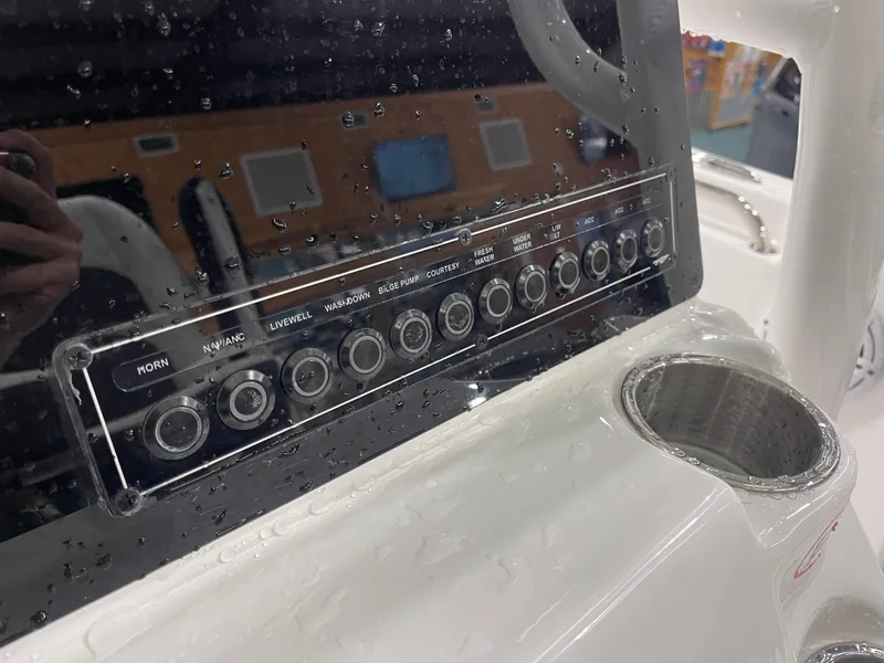 Slide: The Image of Control panel of 2025 Tidewater 210LXF boat with water droplets. - 22