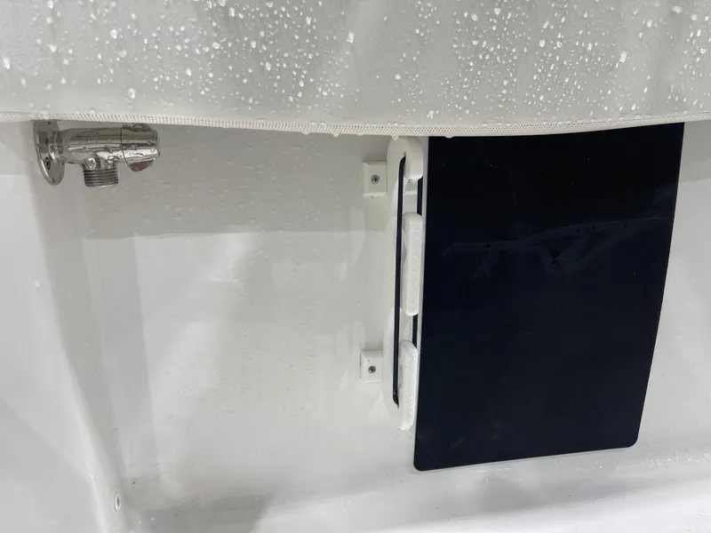 Slide: The Image of 2025 Tidewater 210LXF boat detail with water droplets on a white surface. - 26