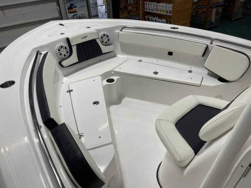 Slide: The Image of 2025 Tidewater 210LXF boat interior with seating and speakers in a showroom. - 29