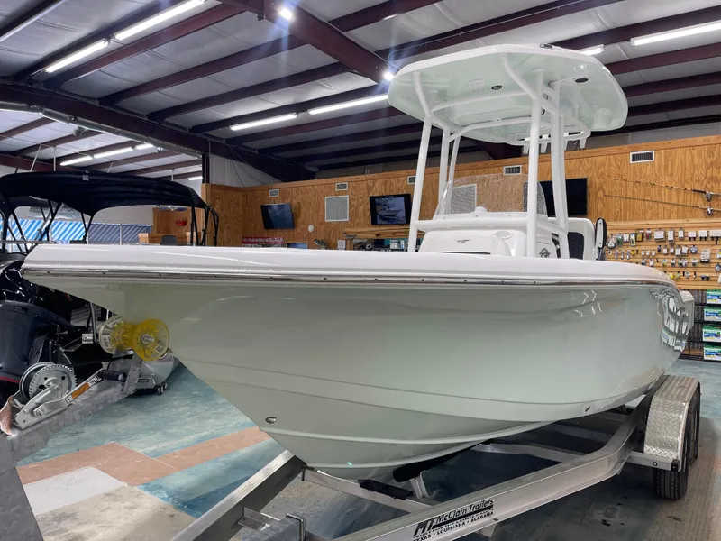 Slide: The Image of 2025 Tidewater 210LXF boat on trailer in showroom, under bright lighting. - 6