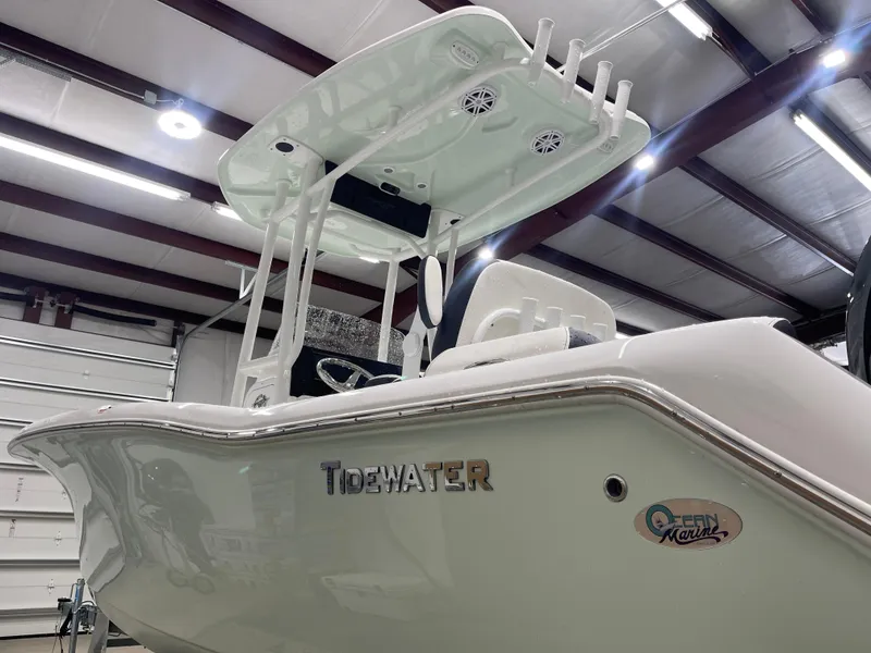 Slide: The Image of 2025 Tidewater 210LXF boat in a well-lit indoor showroom. - 7