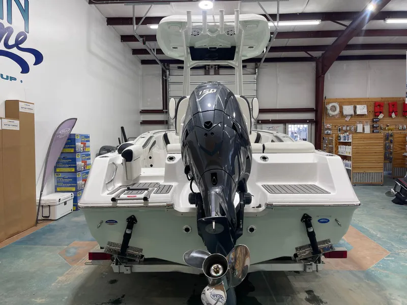 Slide: The Image of 2025 Tidewater 210LXF boat in showroom, featuring powerful outboard motor. - 9