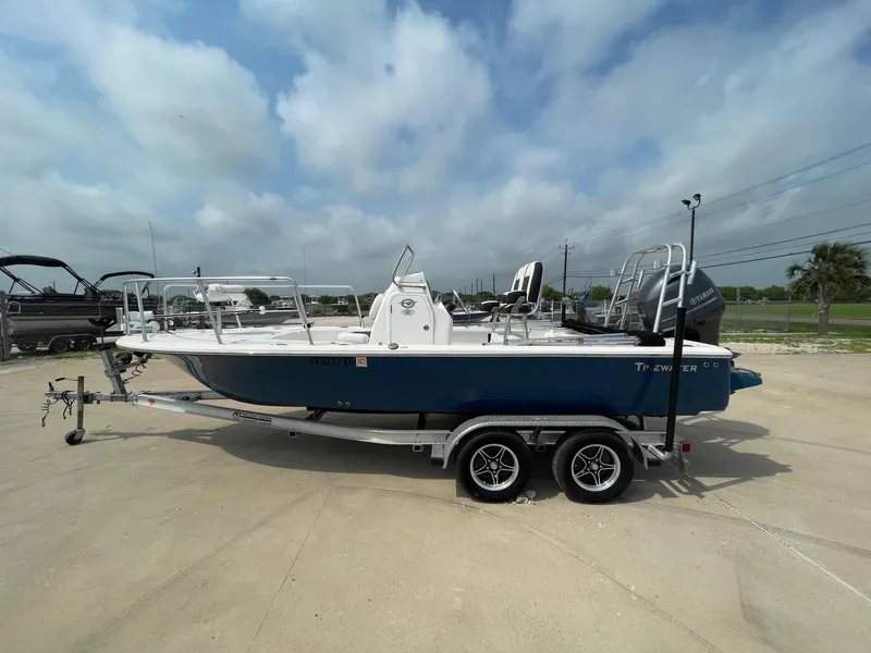 Slide: The Image of 2022 Tidewater 2110BM boat on trailer under cloudy sky. - 1