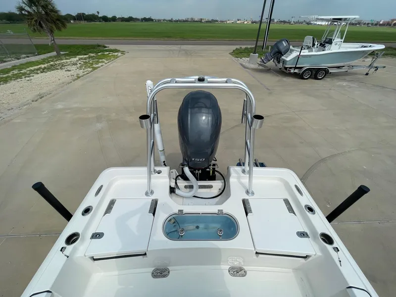 Slide: The Image of 2022 Tidewater 2110BM boat with outboard motor, parked on concrete surface. - 10