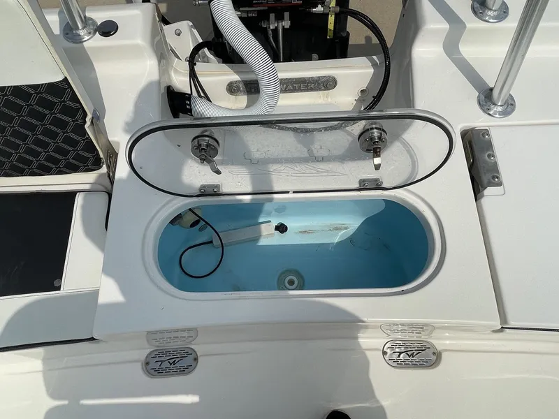 Slide: The Image of 2022 Tidewater 2110BM boat livewell with open lid and visible plumbing. - 14