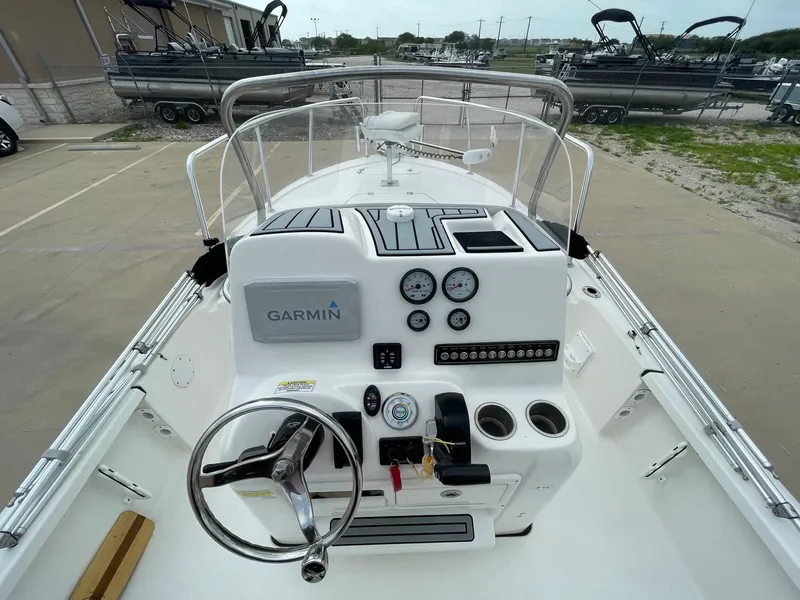 Slide: The Image of 2022 Tidewater 2110BM boat dashboard with Garmin navigation system and steering wheel. - 21