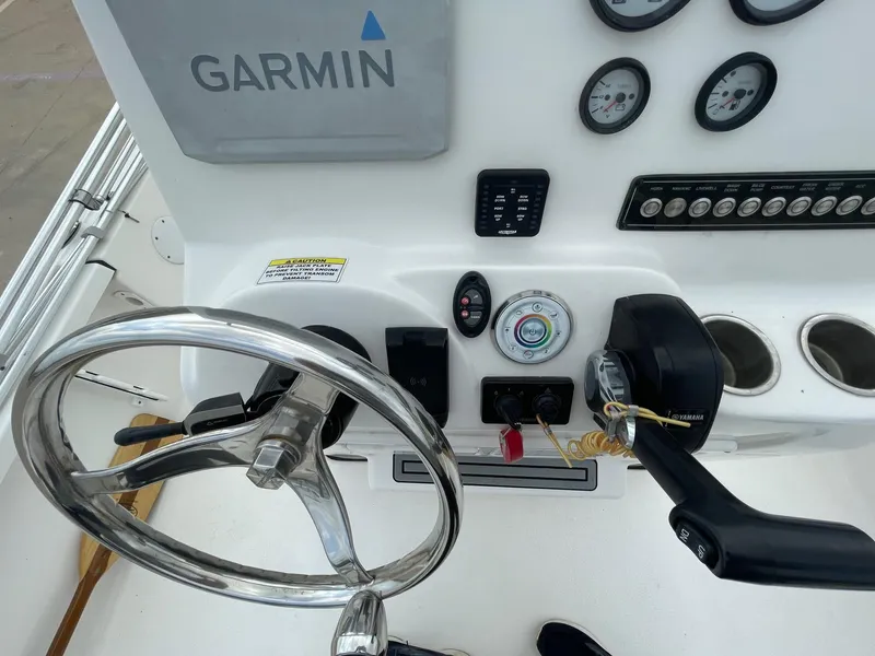 Slide: The Image of 2022 Tidewater 2110BM boat dashboard with Garmin navigation and Yamaha controls. - 23