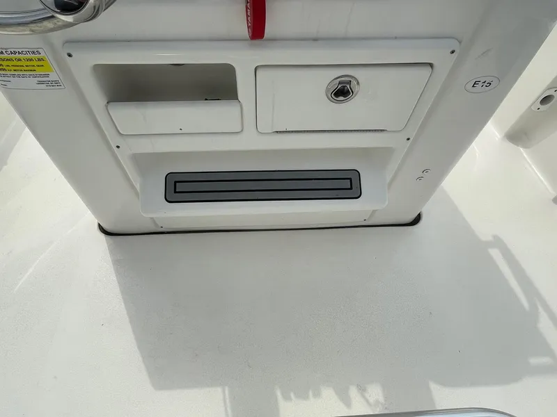 Slide: The Image of 2022 Tidewater 2110BM boat console with storage compartments and control panel. - 25