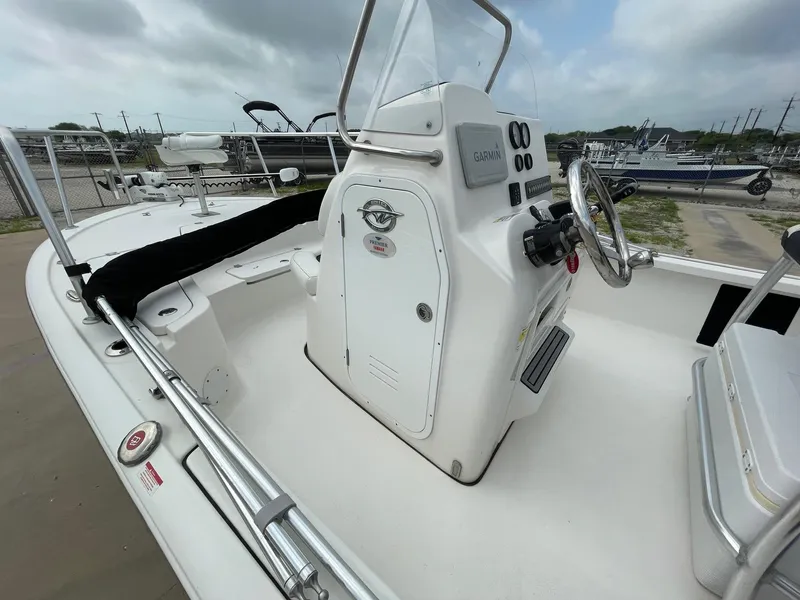 Slide: The Image of 2022 Tidewater 2110BM boat interior with steering console and Garmin equipment. - 27