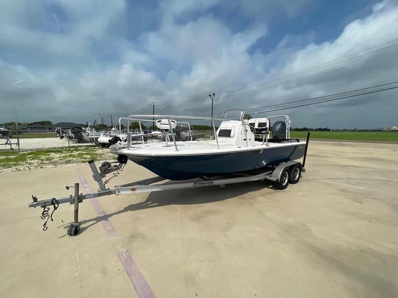 Slide: The Image of 2022 Tidewater 2110BM boat on trailer under cloudy sky. - 3