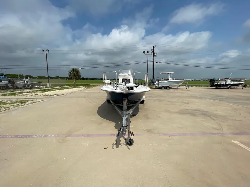 Slide: The Image of 2022 Tidewater 2110BM boat on trailer in parking lot under cloudy sky. - 5