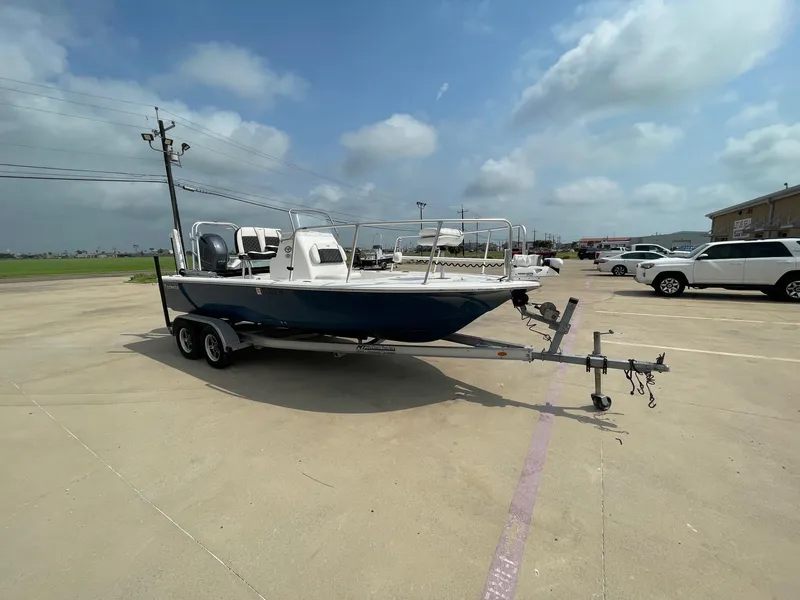 Slide: The Image of 2022 Tidewater 2110BM boat on trailer in parking lot under cloudy sky. - 6